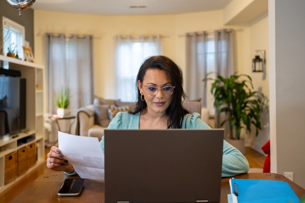 Woman looking at a laptop computer.