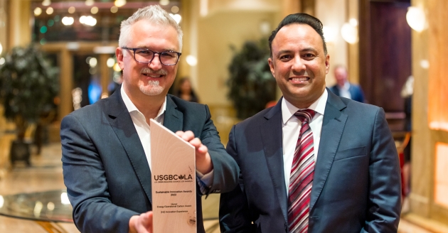 Neil Navin, vice president, clean energy innovations, and Jawaad Malik, vice president of strategy and sustainability, and chief environmental officer, accept the USGBC-LA sustainability award.